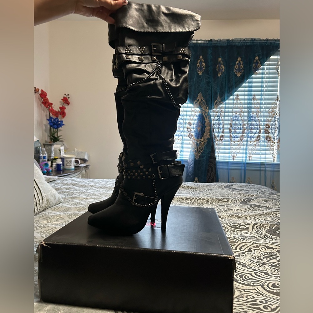 Woman’s high black boots
